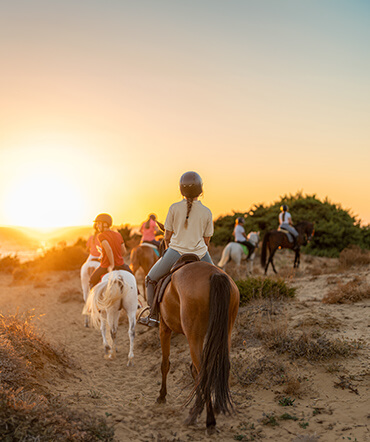 family-horseback-ride-at-sunset